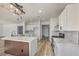 Modern kitchen with a large island, white cabinetry, and stainless steel appliances at 4871 Charlemagne Ave, Las Vegas, NV 89130