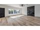 Bright living room featuring hardwood floors, multiple windows, and a modern fireplace at 4871 Charlemagne Ave, Las Vegas, NV 89130