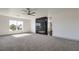 Inviting living room features plush carpet and a black fireplace accent wall at 4871 Charlemagne Ave, Las Vegas, NV 89130