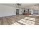 Bright, open-concept living room and kitchen features hardwood floors and modern design elements at 4871 Charlemagne Ave, Las Vegas, NV 89130