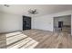 Open living room with hardwood floors, a ceiling fan, and a modern fireplace at 4871 Charlemagne Ave, Las Vegas, NV 89130