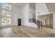 Open living room with hardwood floors, a staircase, high ceilings and several windows at 4871 Charlemagne Ave, Las Vegas, NV 89130