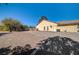 Large gravel backyard with a view of the house at 5105 Kingsbridge Dr, Las Vegas, NV 89130
