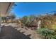 Landscaped backyard with gravel, plants, and a pergola at 5105 Kingsbridge Dr, Las Vegas, NV 89130