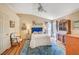 Spacious bedroom with a blue upholstered bed, wood floors, and large windows at 5105 Kingsbridge Dr, Las Vegas, NV 89130