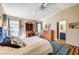 A bright bedroom features wood floors, decor, and an ensuite bathroom at 5105 Kingsbridge Dr, Las Vegas, NV 89130