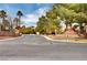 Palm View community entrance with lush landscaping and signage at 5105 Kingsbridge Dr, Las Vegas, NV 89130