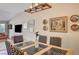 Dining room with glass table, seating for six, and stylish decor at 5105 Kingsbridge Dr, Las Vegas, NV 89130