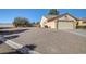 Single-story home with a two-car garage, desert landscaping, and a large lot at 5105 Kingsbridge Dr, Las Vegas, NV 89130