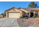 Charming single-story home featuring a two-car garage and a well-maintained desert landscape at 5105 Kingsbridge Dr, Las Vegas, NV 89130