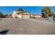 Well-maintained home with a gravel driveway and desert landscaping at 5105 Kingsbridge Dr, Las Vegas, NV 89130