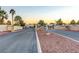 Gated entrance to community with guard house and landscaping at 5105 Kingsbridge Dr, Las Vegas, NV 89130