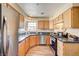 This bright kitchen features wood cabinets, stainless steel appliances, and granite countertops at 5105 Kingsbridge Dr, Las Vegas, NV 89130