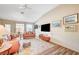 Living room with hardwood floors, leather sofas, and a large window at 5105 Kingsbridge Dr, Las Vegas, NV 89130