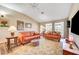 Inviting living room with comfortable seating, natural light, and a ceiling fan at 5105 Kingsbridge Dr, Las Vegas, NV 89130