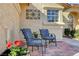 Inviting outdoor patio space with decorative chairs and a well-maintained brick pathway at 5105 Kingsbridge Dr, Las Vegas, NV 89130