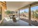 Covered patio with table and chairs, offering an outdoor dining space at 5105 Kingsbridge Dr, Las Vegas, NV 89130