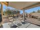 Covered patio with two white chairs and small table at 5105 Kingsbridge Dr, Las Vegas, NV 89130