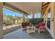 Covered patio with wicker chairs and small table, perfect for relaxing at 5105 Kingsbridge Dr, Las Vegas, NV 89130