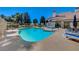 Inviting kidney-shaped pool with surrounding lounge chairs at 5105 Kingsbridge Dr, Las Vegas, NV 89130