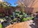 Landscaped backyard with decorative stone and garden at 5988 Pirates Delight Ave, Las Vegas, NV 89139