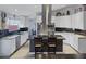 Well-lit kitchen with granite countertops, stainless steel appliances and a view to the dining area at 6308 Canyon Ridge Dr, Las Vegas, NV 89108