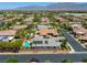 Beautiful aerial view of the backyard with pool, neighborhood, and mountain views in distance at 6425 Orto Botanico Ct, Las Vegas, NV 89131
