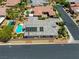 Gorgeous home featuring solar panels, an outdoor pool, lush landscaping, and a porte-cochere at 6425 Orto Botanico Ct, Las Vegas, NV 89131