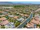 Expansive aerial view of a neighborhood, showcasing rooftops and desert mountain backdrop at 6425 Orto Botanico Ct, Las Vegas, NV 89131