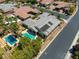 Aerial image shows in-ground pool, lush landscaping, covered patio, solar panels, and a porte-cochere at 6425 Orto Botanico Ct, Las Vegas, NV 89131