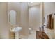 Powder bathroom featuring a pedestal sink, decorative mirror, and neutral color scheme at 6425 Orto Botanico Ct, Las Vegas, NV 89131