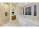 Bathroom with a large soaking tub, fireplace, and a tiled area at 6425 Orto Botanico Ct, Las Vegas, NV 89131