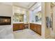 Spacious bathroom with dual vanities, fireplace, and soaking tub with tile surround at 6425 Orto Botanico Ct, Las Vegas, NV 89131