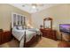 Bedroom with wood furniture, a ceiling fan, and large shuttered windows at 6425 Orto Botanico Ct, Las Vegas, NV 89131