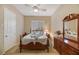 Bedroom with neutral walls, wood furniture, and a shuttered window at 6425 Orto Botanico Ct, Las Vegas, NV 89131