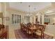 Formal dining room featuring a chandelier, shuttered windows, and a spacious layout with an ornate rug at 6425 Orto Botanico Ct, Las Vegas, NV 89131