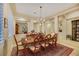 Dining area with a large table, decorative chandelier, and tiled floors, perfect for entertaining guests at 6425 Orto Botanico Ct, Las Vegas, NV 89131