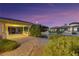 Charming home exterior showcasing architectural details, pavers, and lush landscaping at dusk at 6425 Orto Botanico Ct, Las Vegas, NV 89131