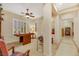 Bright game room with a ceiling fan, shuttered windows, and view of the hallway leading to other rooms at 6425 Orto Botanico Ct, Las Vegas, NV 89131