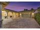 Spacious two-car garage with an extended driveway and elegant architectural details at 6425 Orto Botanico Ct, Las Vegas, NV 89131
