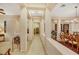Elegant hallway with tile flooring and decorative columns leading to the dining area and other rooms at 6425 Orto Botanico Ct, Las Vegas, NV 89131