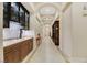 Hallway with tile floors, arched ceilings, wine bar and views of the entryway at 6425 Orto Botanico Ct, Las Vegas, NV 89131
