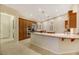 Kitchen with stainless appliances, wood cabinetry, an island and granite countertops at 6425 Orto Botanico Ct, Las Vegas, NV 89131