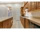 Well-appointed kitchen includes granite counters, gas cooktop, tile floors, and wood cabinets at 6425 Orto Botanico Ct, Las Vegas, NV 89131