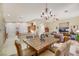 Open-concept living and dining area with fireplace, tile floors, kitchen access, and lots of natural light at 6425 Orto Botanico Ct, Las Vegas, NV 89131