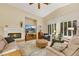 Inviting living room with a fireplace, large windows, and comfortable seating, perfect for relaxation at 6425 Orto Botanico Ct, Las Vegas, NV 89131