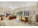 Open-concept living room and dining area with a fireplace, tile flooring, and ample natural light at 6425 Orto Botanico Ct, Las Vegas, NV 89131
