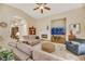 Cozy living room with a fireplace, ceiling fan, and neutral decor, offering a comfortable gathering space at 6425 Orto Botanico Ct, Las Vegas, NV 89131