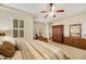 Comfortable main bedroom featuring neutral tones, ceiling fan, and plenty of natural light at 6425 Orto Botanico Ct, Las Vegas, NV 89131