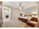 Cozy main bedroom featuring a fireplace, ceiling fan, and en-suite bathroom access at 6425 Orto Botanico Ct, Las Vegas, NV 89131